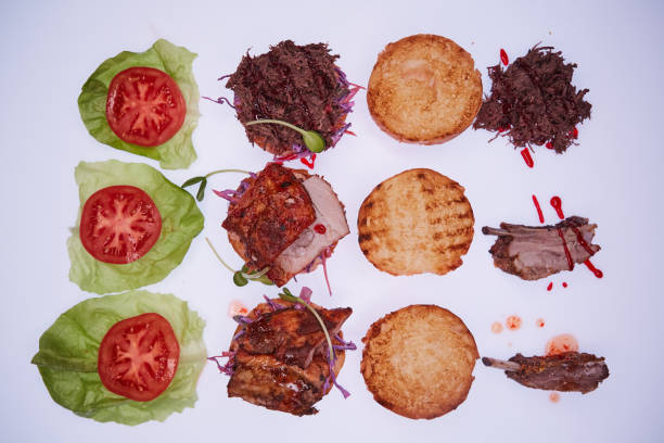 istock Three open burgers with different fillings with a torn pork, with ribs and pork ribs on a white table 985232198