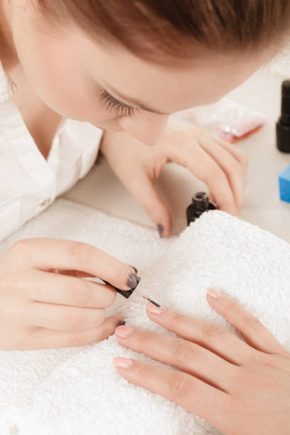 istock Woman in beauty salon getting manicure done. 985233012