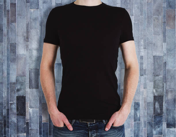 istock Man wearing blank shirt on wooden background 985233220