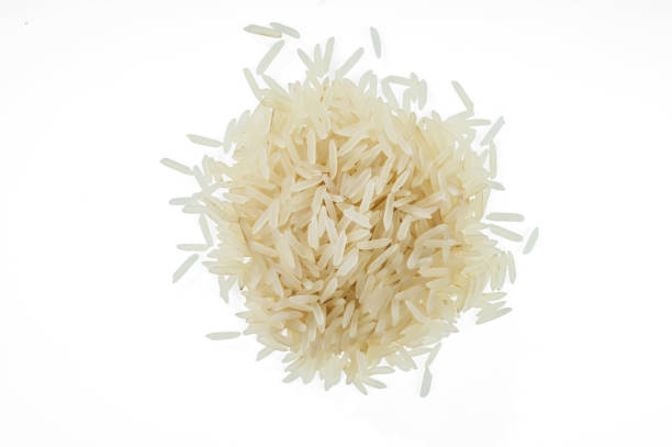 istock A bunch of white raw long-grain rice. Isolated on white background 985246054