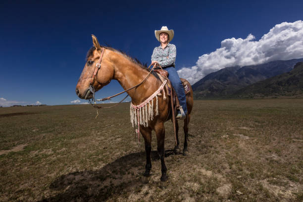 istock Smiling Cowgirl on Horseback 985246774