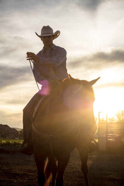 istock Partially Silhouetted Cowboy at Sunset 985246934
