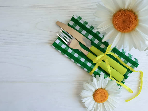 istock fork knife camomile on a wooden background 985262718