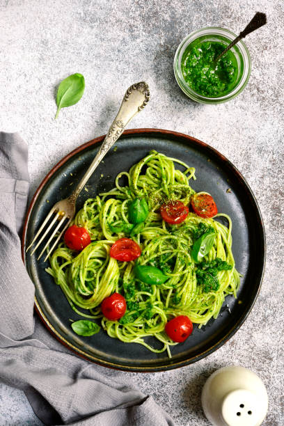 istock Spaghetti pasta with pesto sauce and cherry tomatoes 985266148