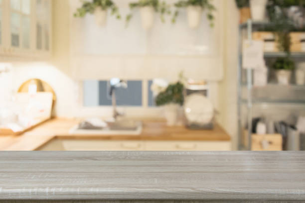istock Blurred background. Modern defocused pastel kitchen with wooden tabletop and space for you. 985270026