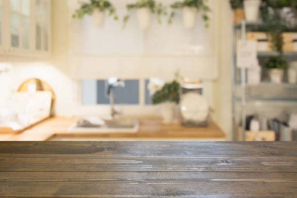 istock Blurred background. Modern defocused pastel kitchen with wooden tabletop and space for you. 985270360