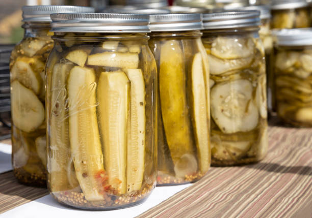 Natural pickles in jars sold at a farmer's market stand