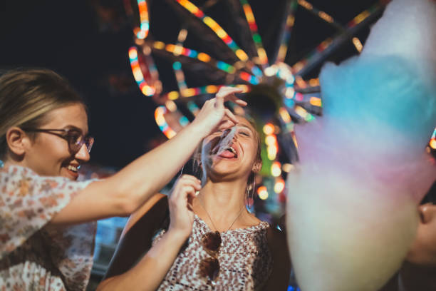 istock Friends sharing candy cotton at night 985276162