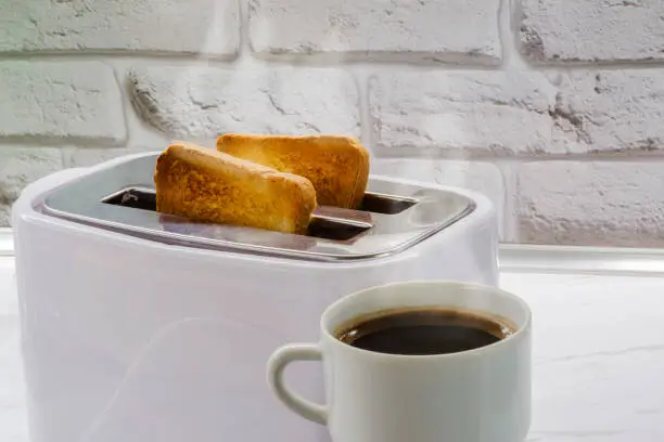 a cup of coffee and toast in a toaster