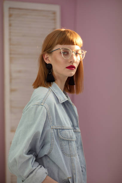istock Fashionable redhead woman posing in studio. 985293394