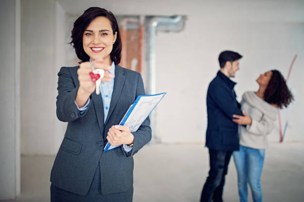 istock Real estate agent is holding key for a new apartment 985318986