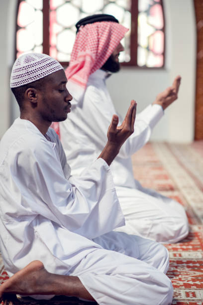 istock Two religious muslim man praying together inside the mosque 985343308