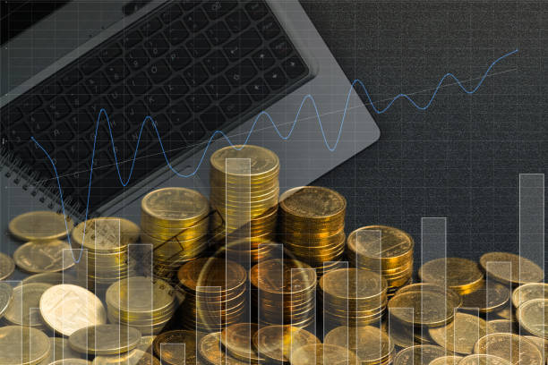 istock Double exposure of coin stack with office supplies, columns of coins on office work essential tools or item, business and financial concept. 985347292