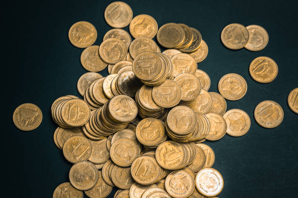 istock Savings, increasing columns of coins, piles of coins arranged as a graph in dark room, business banking concept. 985347318