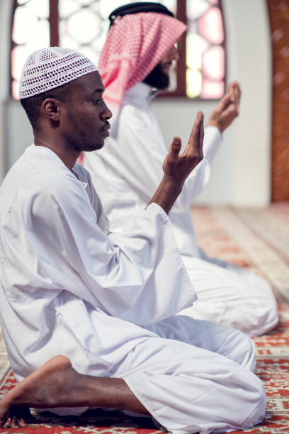 istock Two religious muslim man praying together inside the mosque 985350514