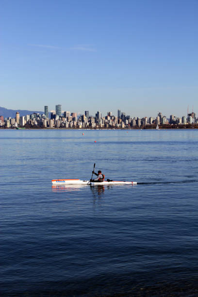 Blue Paddling A kayak on English Bay, Vancouver, Canada. beach english bay vancouver skyline stock pictures, royalty-free photos & images