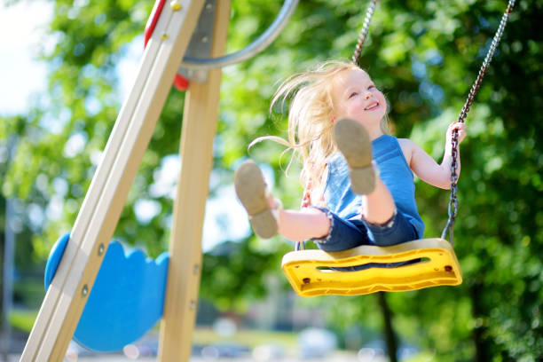 istock Cute little girl having fun on a playground 985354352
