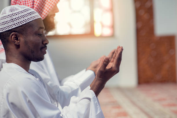 istock Two religious muslim man praying together inside the mosque 985354456