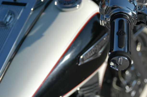 Close up of a Harley Davidson Fat Boy, classic American Motorcycle, in the sun, sunshine reflecting off the chrome. Very customized Harley Davidson motorcycle. Provo, Utah, USA - 26 September 2003: Close up of a Harley Davidson Fat Boy, classic American Motorcycle, in the sun, sunshine reflecting off the chrome. Very customized Harley Davidson motorcycle. harley davidson fat boy stock pictures, royalty-free photos & images