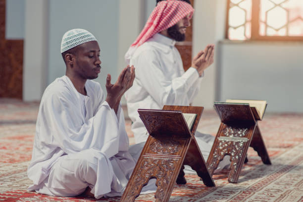istock Two religious muslim man praying together inside the mosque 985359478