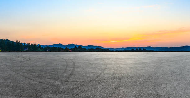 istock Asphalt square and hills silhouette 985363860