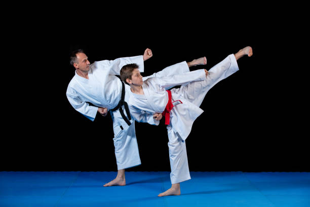 istock Male karate instructor training little children in dojo 985364946