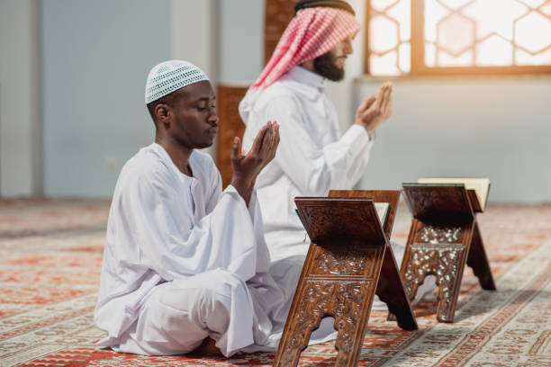 istock Two religious muslim man praying together inside the mosque 985368288