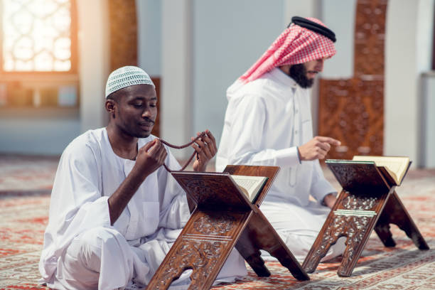 istock Two religious muslim man praying together inside the mosque 985371162