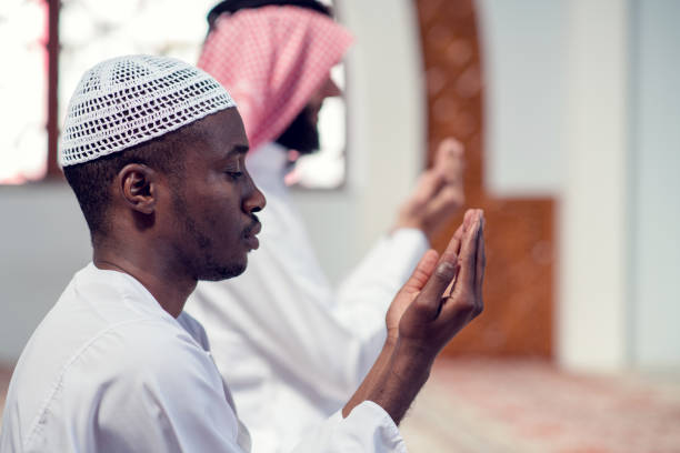 istock Two religious muslim man praying together inside the mosque 985374234