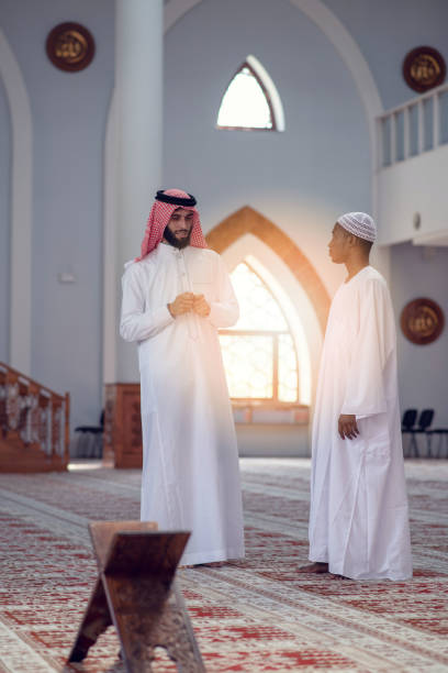istock Two religious Muslim man walking together inside the mosque 985374522