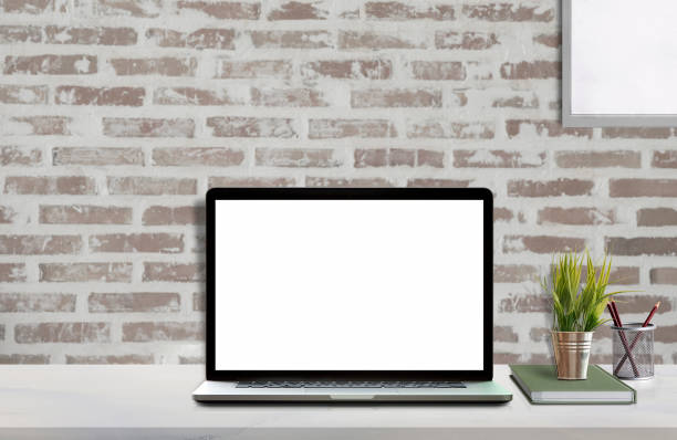 istock Mock up workspace with blank screen laptop and mockup poster 985388128