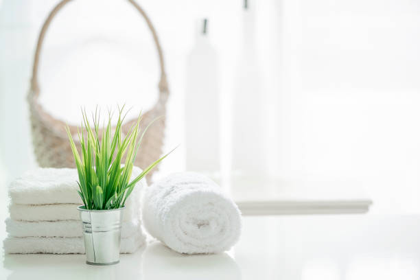 istock Towels on white table with copy space on blurred bathroom background 985388622
