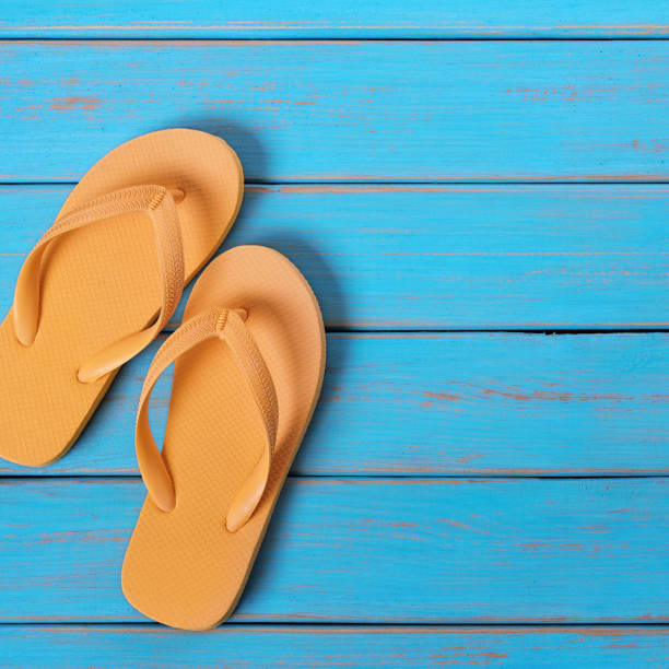 istock Flip flops old weathered blue beach wood 985421584
