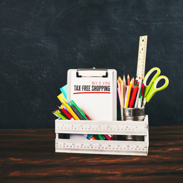 Back to school supplies with clipboard against weathered chalkboard