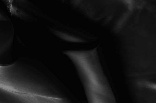istock Soft focus cloth silk black. Take home this black washed silk! The washed black color is a soft, silky hand. Thin and light, it has a liquid drape that stands out when creating soft silhouettes. 985428486