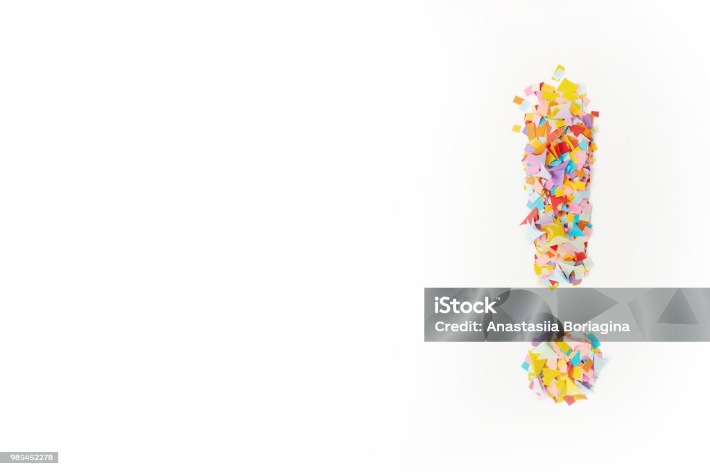 The exclamation mark on a  background from multi-colored confetti, from pieces of color paper. Multi-colored confetti from paper. The exclamation mark on a  background from multi-colored confetti, from pieces of color paper. Banner - Sign Stock Photo