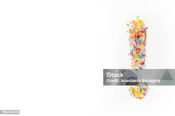 The Exclamation Mark On A Background From Multicolored Confetti From Pieces Of Color Paper Stock Photo - Download Image Now