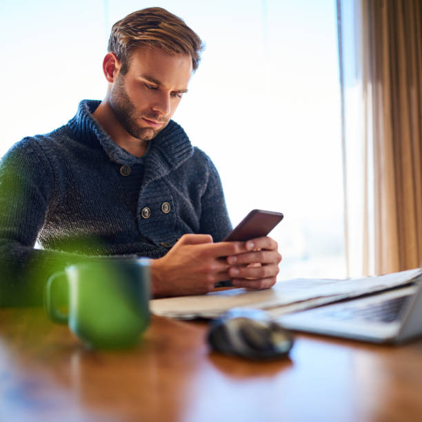 istock Square image of young man texting on his mobile phone 985457884