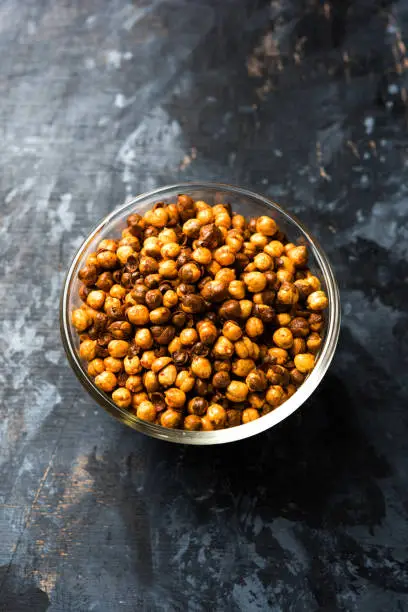 Photo of Roasted Masala Chickpea / chana known as chatpata futana or Phutana in Hindi served in a bowl. Selective focus