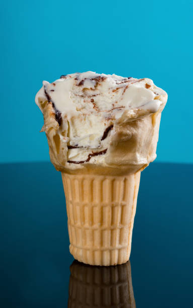 istock ice cream cone on a blue background with some bites 985480570