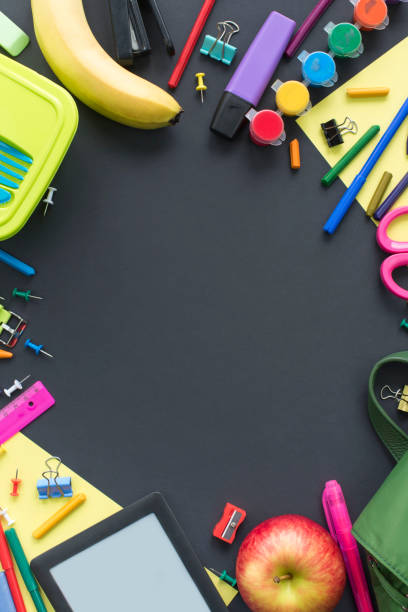 istock Concept back to school apple backpack stationery on black background. 985480678