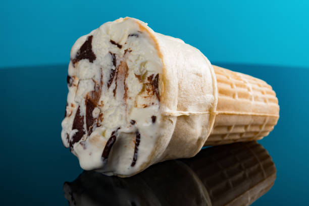 istock ice cream cone on a blue background with some bites 985480810