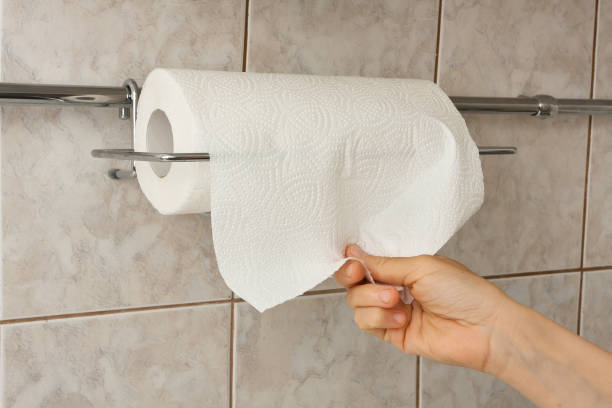 istock woman hand with paper towel 985498390