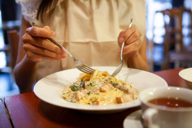 istock A woman eating pasta. 985502970
