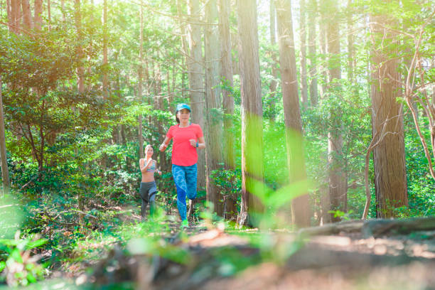 istock Two women running on trail in the mountains 985514486