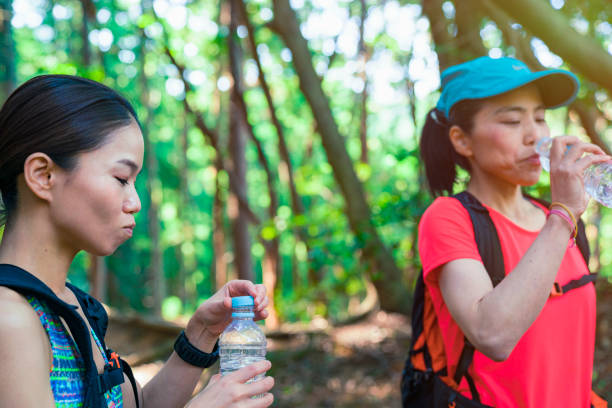 istock Two female hiker Walking around mountain 985514560