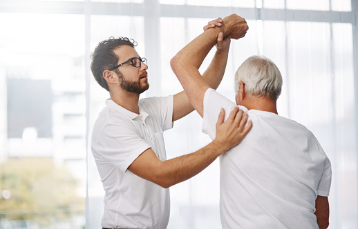 Cropped shot of a young male physiotherapist working with a senior male patient