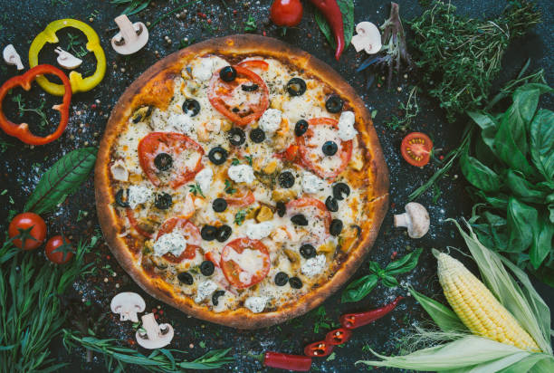 istock Tasty seafood pizza with cherries on a wooden table 985526872