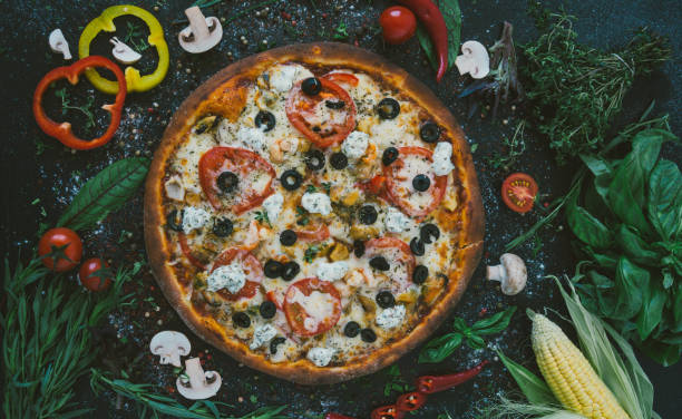 istock Tasty seafood pizza with cherries on a wooden table 985526878