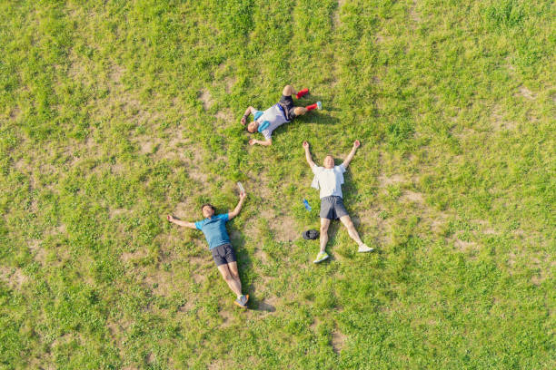 istock Senior men relaxing on the lawn after exercise 985536158